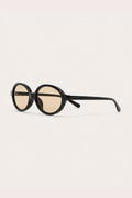 CHAMPAGNE OVAL SUNGLASSES – black oval sunglasses with light champagne lenses, side view