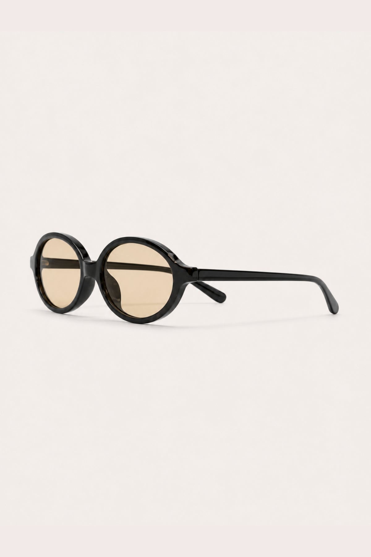 CHAMPAGNE OVAL SUNGLASSES – black oval sunglasses with light champagne lenses, side view